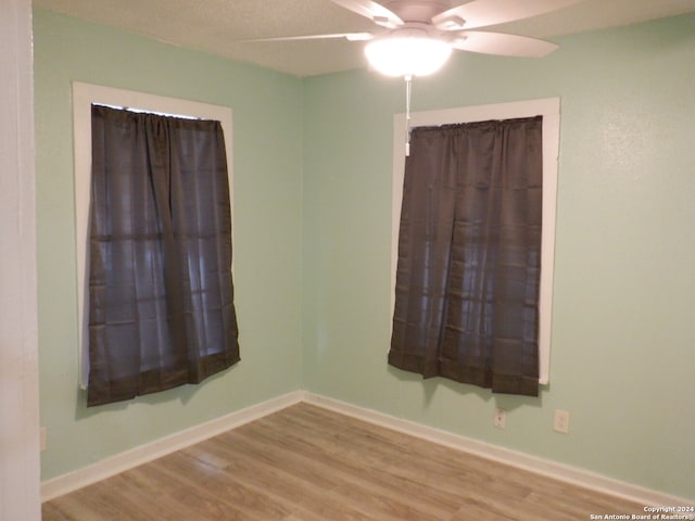 unfurnished room with ceiling fan and light wood-type flooring