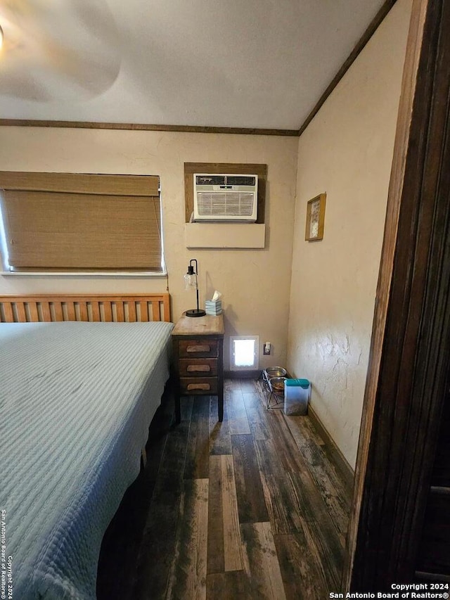 bedroom with an AC wall unit, ornamental molding, and dark hardwood / wood-style flooring