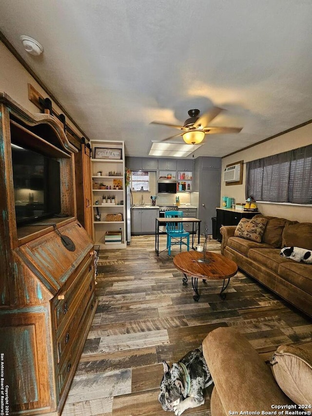 living room with ceiling fan, a wall mounted AC, and wood-type flooring