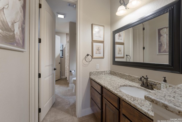 bathroom with tile patterned floors, vanity, and toilet