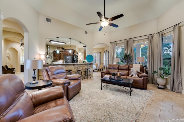 tiled living room with ceiling fan