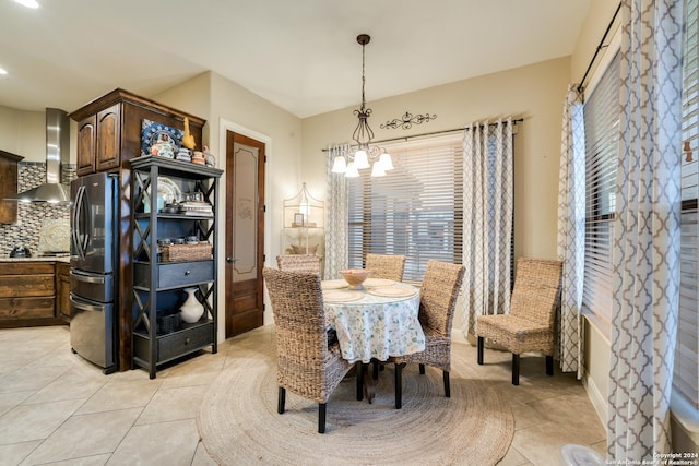 dining area featuring light tile patterned flooring and a chandelier