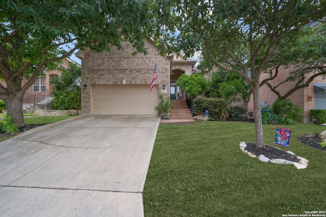 obstructed view of property featuring a garage and a front yard