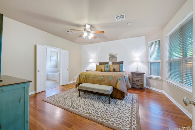 bedroom featuring hardwood / wood-style flooring, ceiling fan, and ensuite bathroom