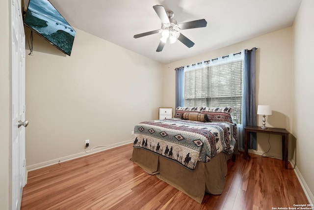 bedroom with ceiling fan and hardwood / wood-style floors