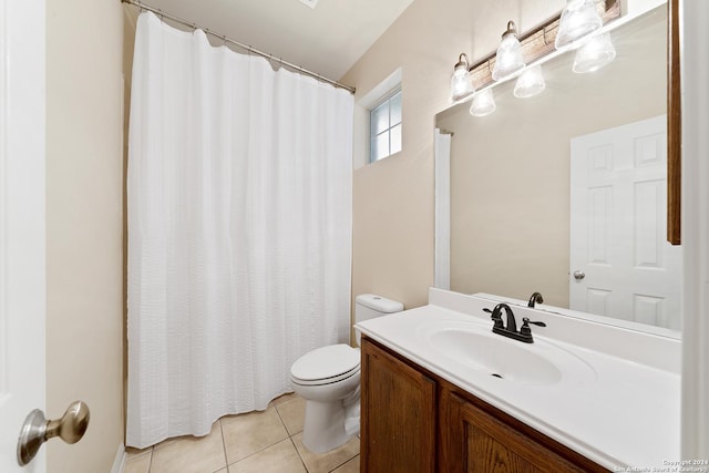 bathroom featuring vanity, toilet, and tile patterned flooring