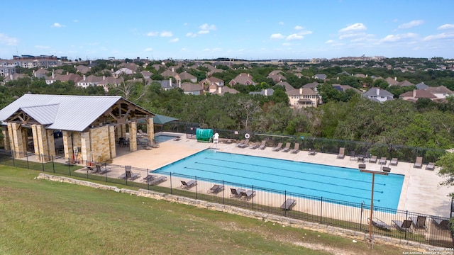 view of pool with a patio and a lawn