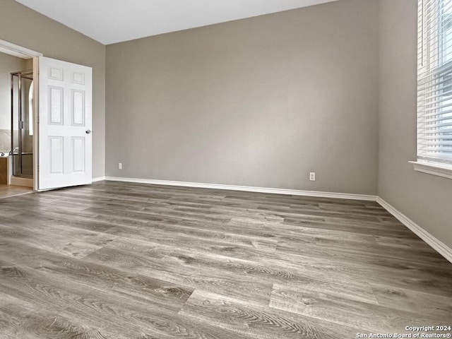 spare room with hardwood / wood-style flooring