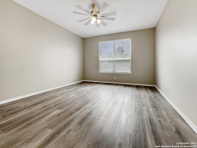 empty room with hardwood / wood-style flooring and ceiling fan