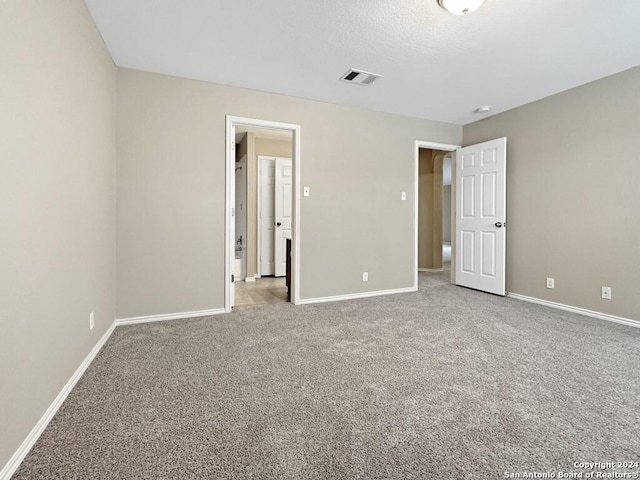 unfurnished bedroom featuring light carpet