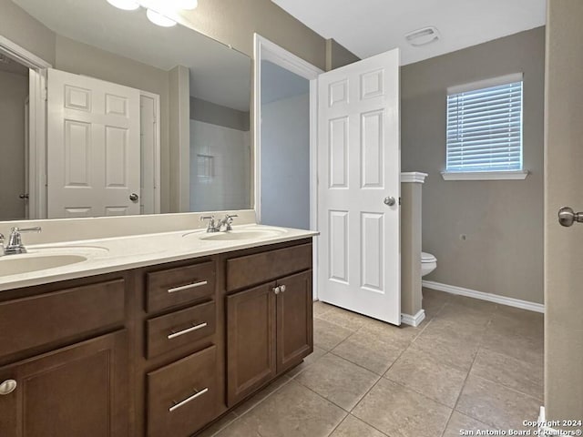 bathroom featuring tile patterned floors, vanity, and toilet