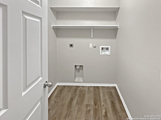 washroom with gas dryer hookup, hookup for a washing machine, hardwood / wood-style floors, and hookup for an electric dryer