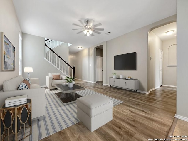 living room featuring ceiling fan and hardwood / wood-style floors