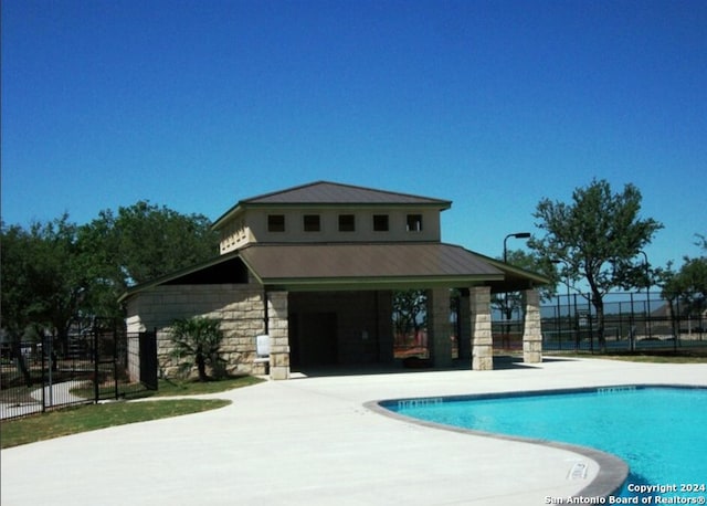 view of swimming pool with a patio