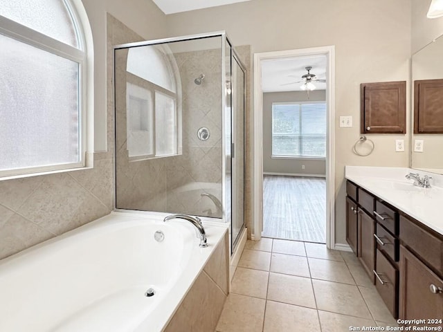 bathroom featuring tile patterned floors, ceiling fan, separate shower and tub, and vanity