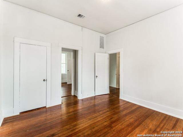 unfurnished bedroom featuring dark wood-type flooring