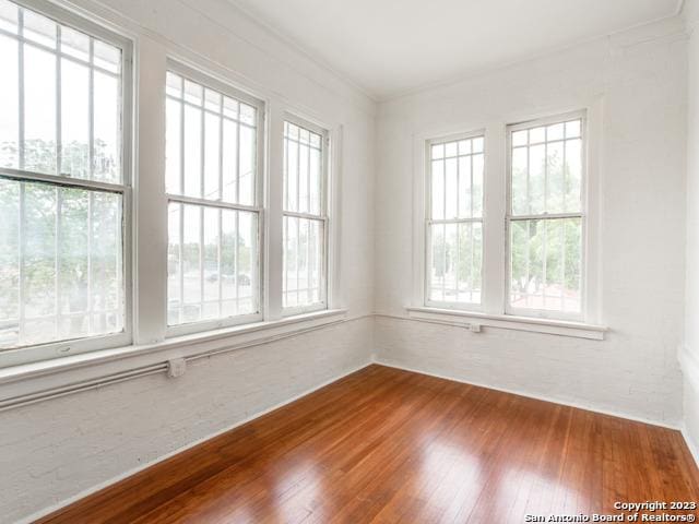 unfurnished room with hardwood / wood-style floors and a wealth of natural light