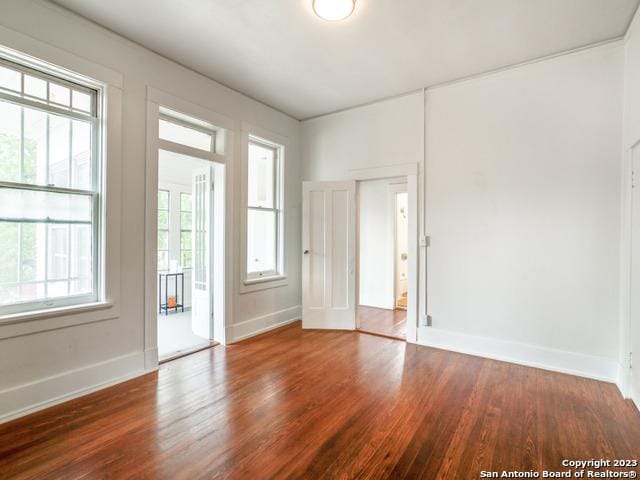 spare room featuring dark wood-type flooring