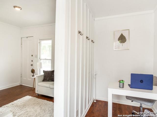 interior space with dark hardwood / wood-style flooring and ornamental molding