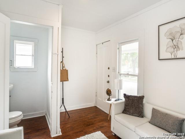 interior space featuring dark hardwood / wood-style floors and crown molding