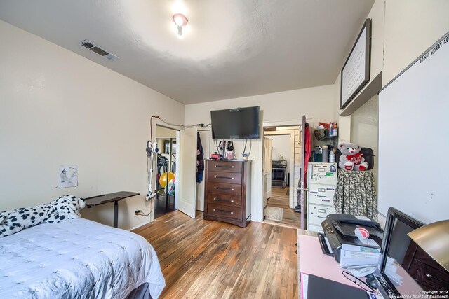 bedroom with dark wood-type flooring