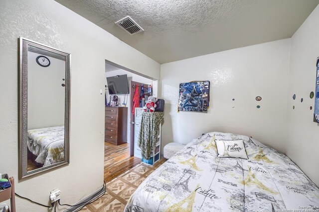 bedroom with dark hardwood / wood-style floors