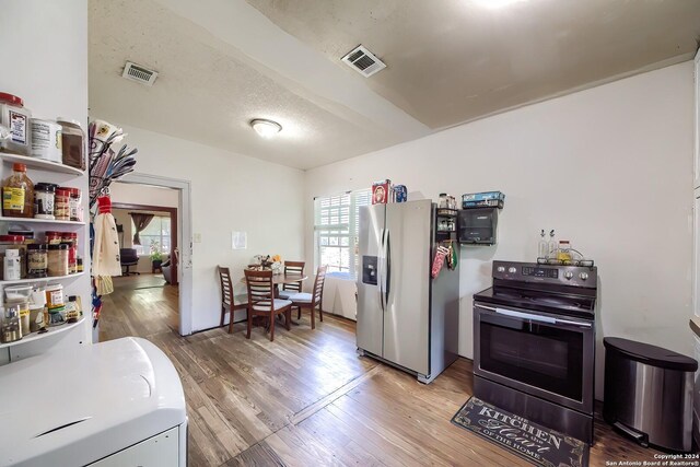 washroom with hardwood / wood-style floors and washing machine and clothes dryer