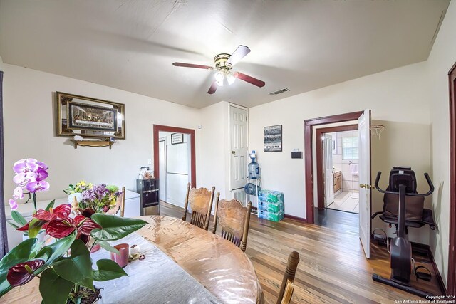 kitchen featuring a textured ceiling, light hardwood / wood-style flooring, stainless steel fridge, and washer / clothes dryer