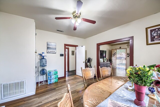 dining space with wood-type flooring and ceiling fan