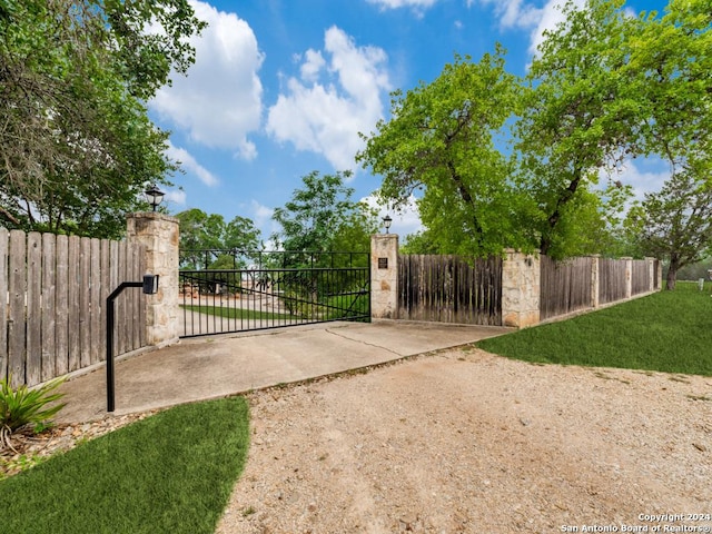 view of gate featuring a yard and fence