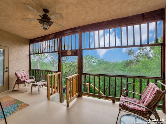 sunroom / solarium featuring ceiling fan