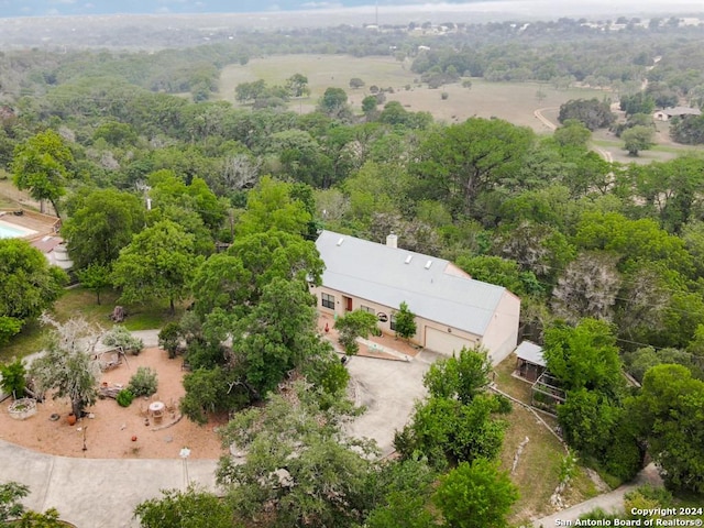 birds eye view of property with a view of trees