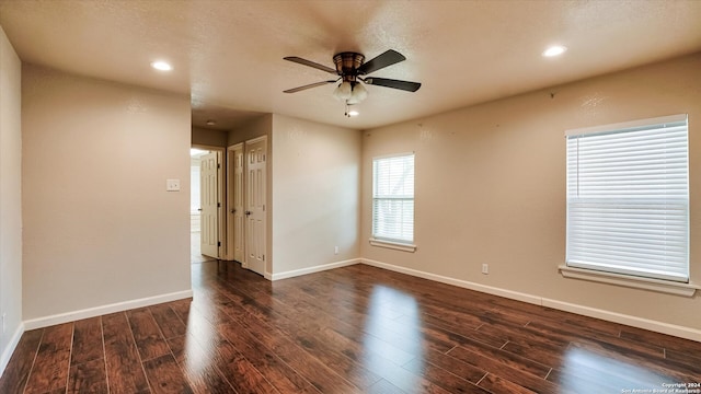 spare room featuring ceiling fan and dark hardwood / wood-style flooring