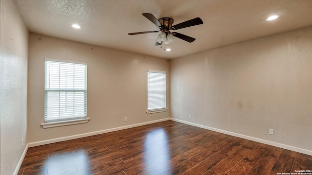 spare room featuring ceiling fan and dark wood-type flooring