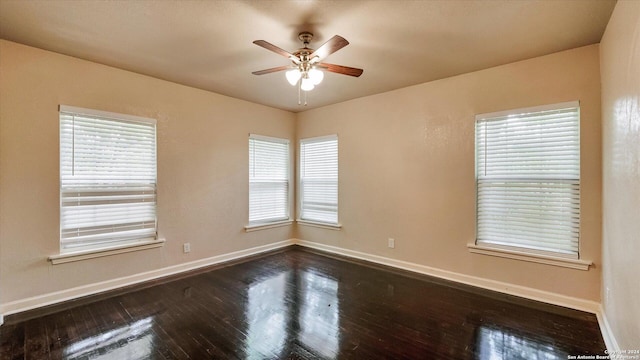 empty room featuring ceiling fan and dark hardwood / wood-style floors