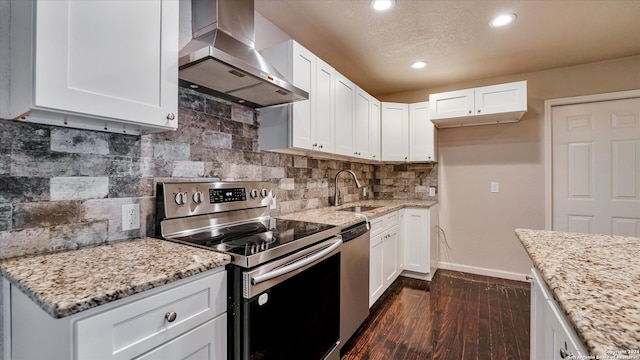 kitchen with white cabinets, sink, wall chimney exhaust hood, and appliances with stainless steel finishes