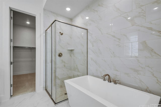 bathroom with plus walk in shower and tile walls