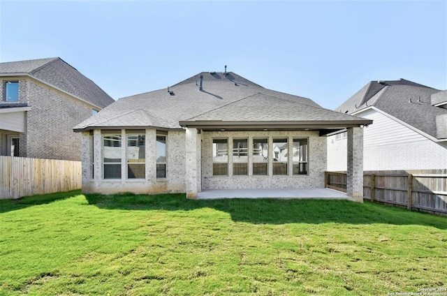 back of property featuring a patio area and a lawn