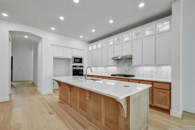 kitchen with white cabinets and a center island with sink