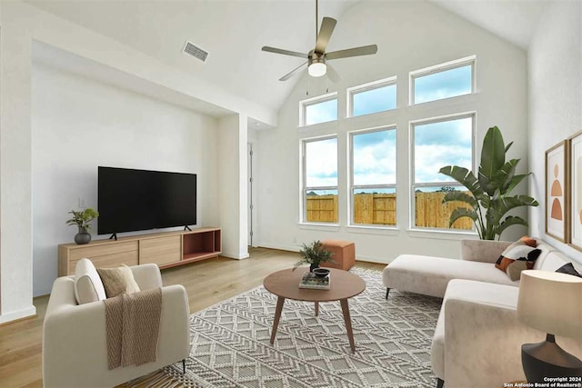 living room featuring wood-type flooring, high vaulted ceiling, and ceiling fan