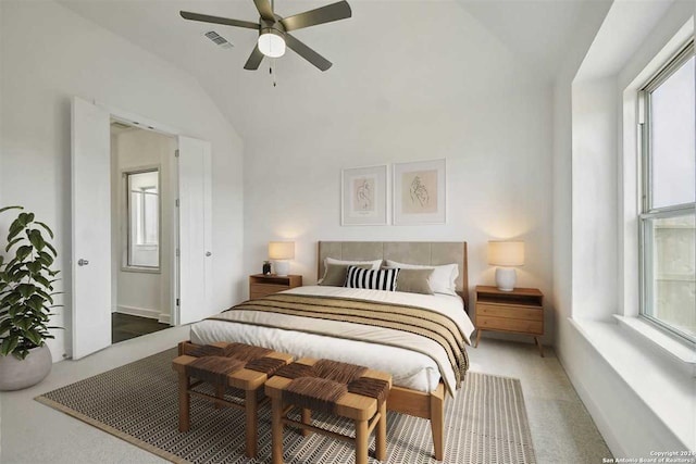 carpeted bedroom with ceiling fan and lofted ceiling