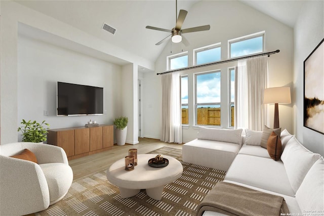 living room with light hardwood / wood-style floors, high vaulted ceiling, and ceiling fan