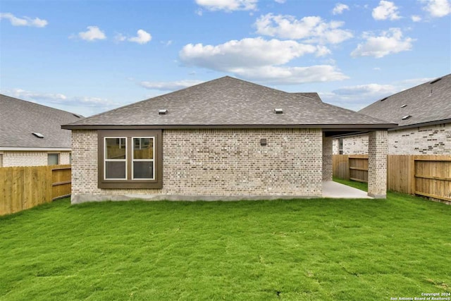 back of property with a patio and a lawn