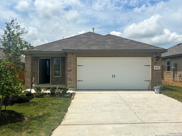 view of front of house with a garage and a front lawn