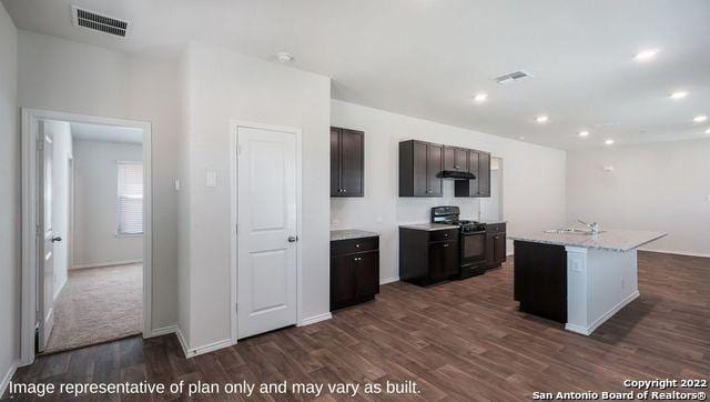 kitchen featuring sink, dark hardwood / wood-style floors, dark brown cabinetry, an island with sink, and black range with gas stovetop