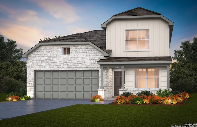 view of front of house featuring a yard and a garage