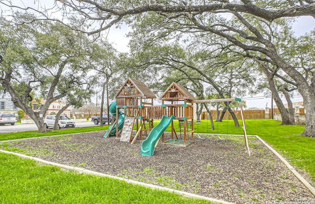 view of playground with a lawn