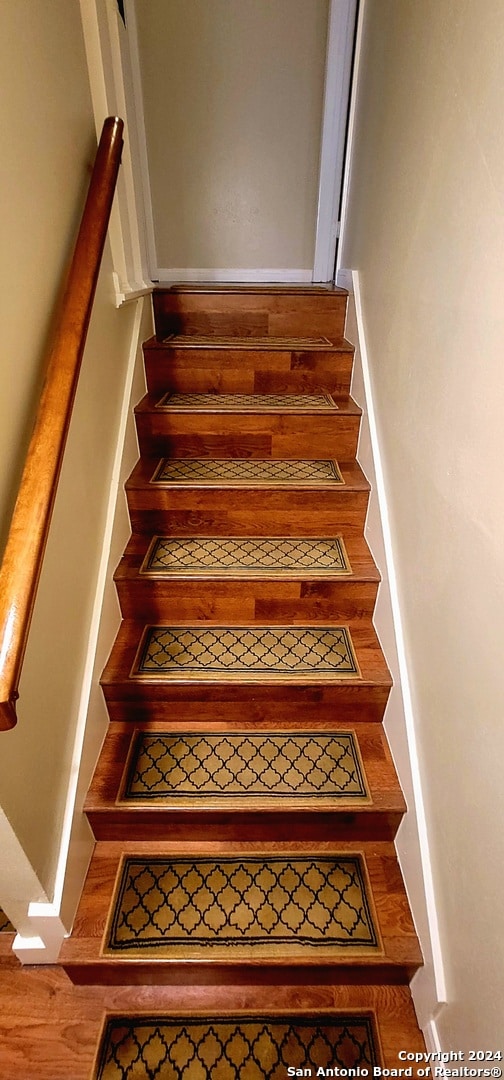 stairway featuring wood-type flooring