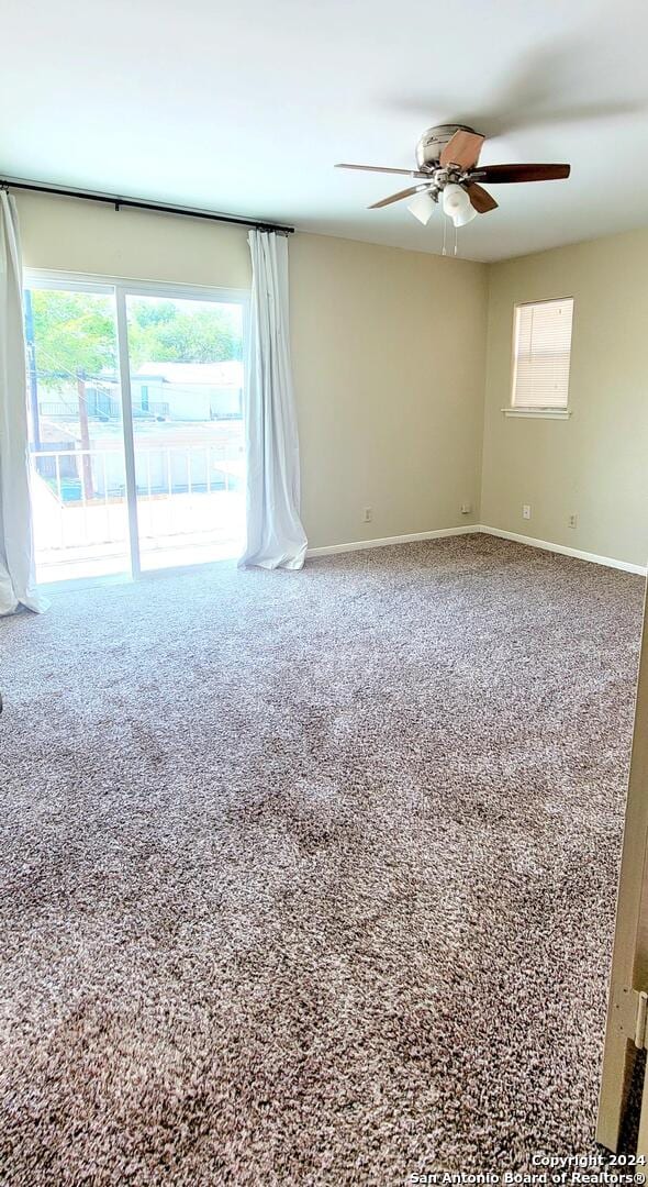 unfurnished room with carpet flooring and ceiling fan