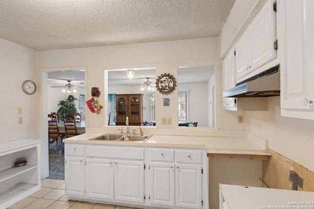 kitchen with ceiling fan, sink, white cabinets, and light tile patterned flooring